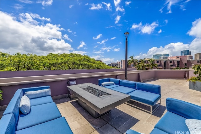 view of patio featuring an outdoor living space with a fire pit