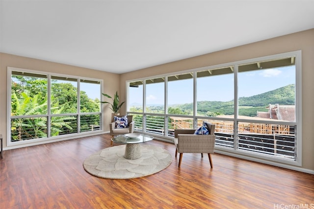 sunroom / solarium featuring a mountain view and a healthy amount of sunlight