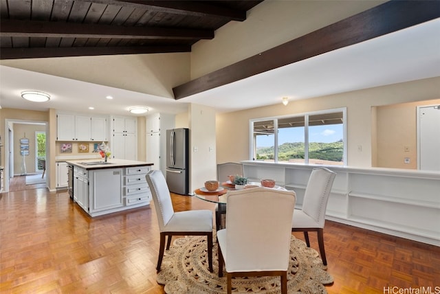 dining area with wood ceiling, high vaulted ceiling, light parquet flooring, beamed ceiling, and sink