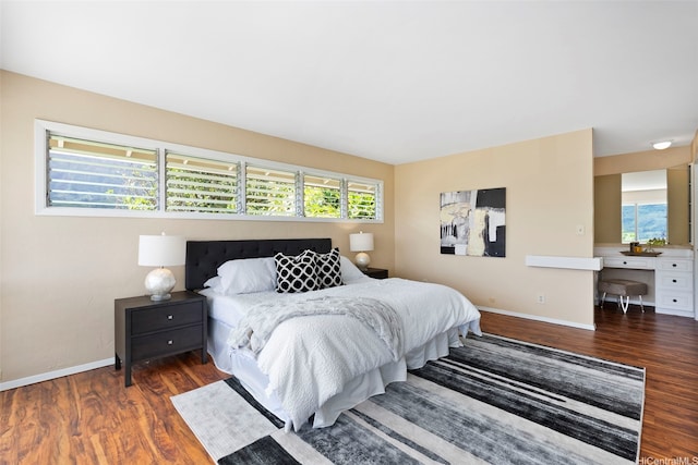 bedroom featuring baseboards and wood finished floors