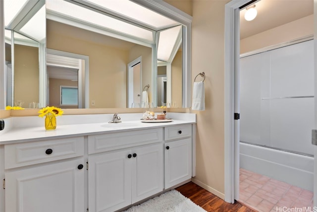 bathroom with shower / bath combination with glass door, vanity, and hardwood / wood-style flooring