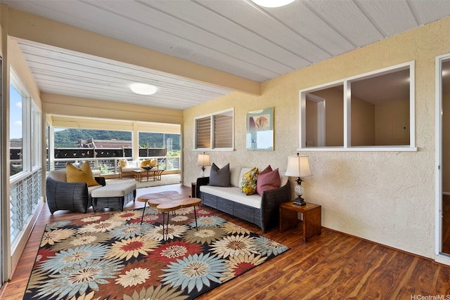 sunroom featuring beamed ceiling