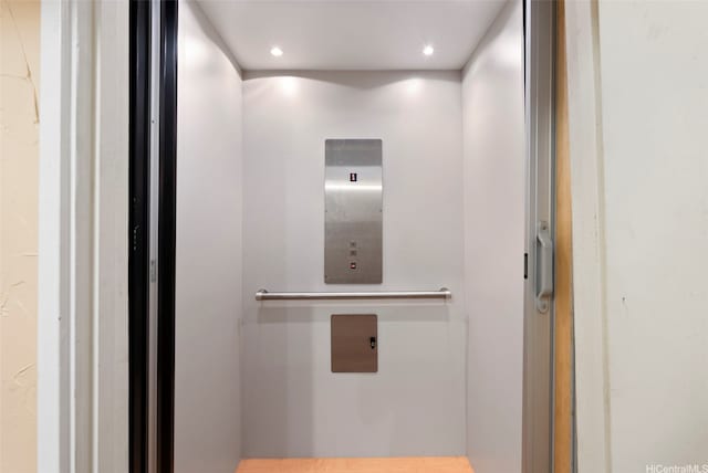 details featuring elevator and recessed lighting