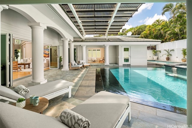 view of swimming pool with a patio and an in ground hot tub