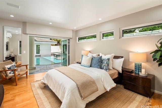 bedroom featuring light hardwood / wood-style flooring and access to exterior