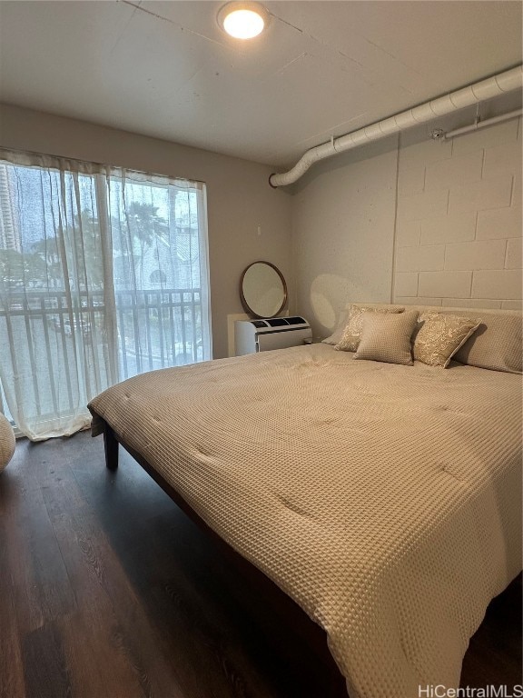 bedroom with dark wood-type flooring