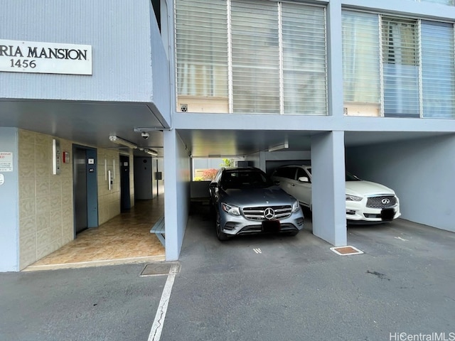 view of vehicle parking featuring elevator