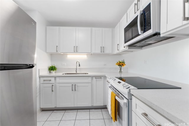 kitchen with sink, appliances with stainless steel finishes, and white cabinets