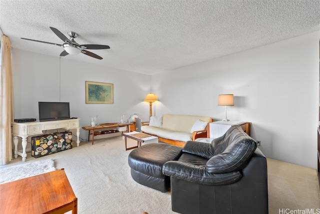 living room featuring ceiling fan, a textured ceiling, and light colored carpet