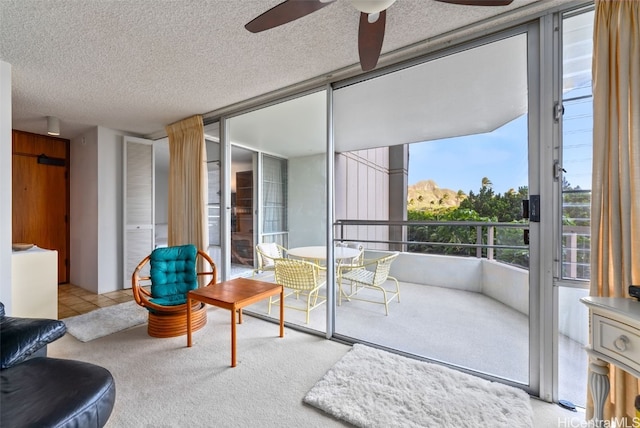 interior space with ceiling fan