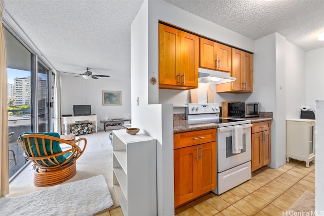 kitchen with ceiling fan, white electric stove, a textured ceiling, and light tile patterned floors