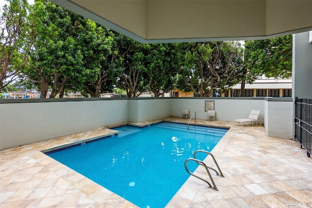 view of swimming pool with a patio area