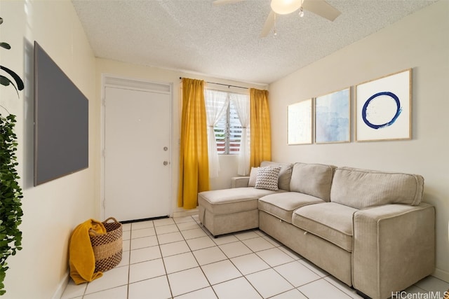 tiled living room with a textured ceiling and ceiling fan