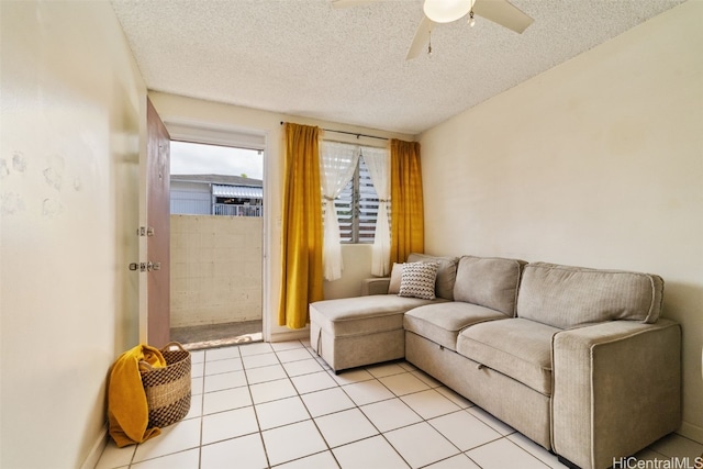 tiled living room with ceiling fan and a textured ceiling