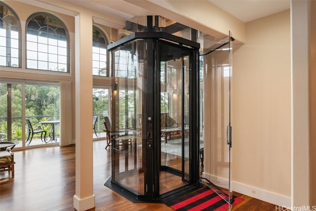 entryway with an inviting chandelier and hardwood / wood-style flooring