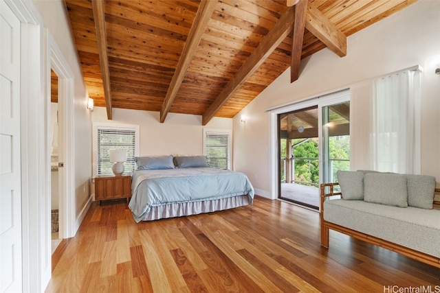 bedroom featuring light hardwood / wood-style floors, vaulted ceiling with beams, multiple windows, and access to outside