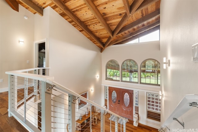 foyer with a wealth of natural light, high vaulted ceiling, and wooden ceiling