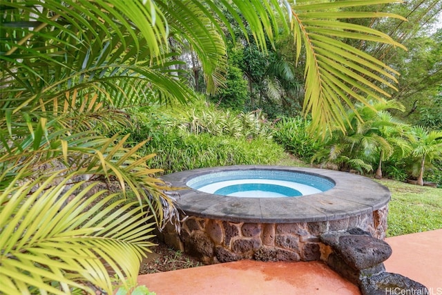 view of swimming pool featuring an in ground hot tub