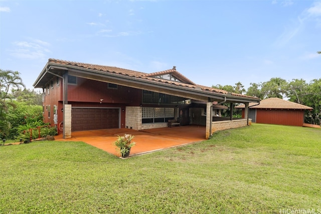 exterior space with a garage and a lawn