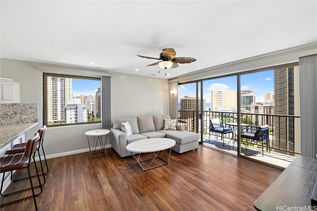 living room with dark hardwood / wood-style floors and ceiling fan