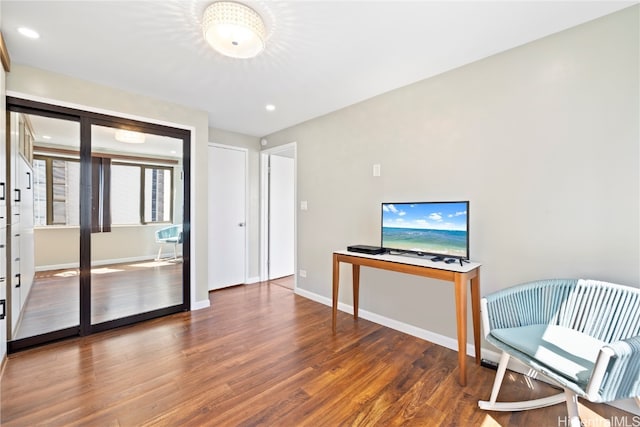 sitting room with dark hardwood / wood-style flooring