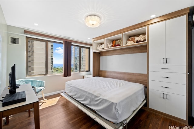 bedroom with dark wood-type flooring