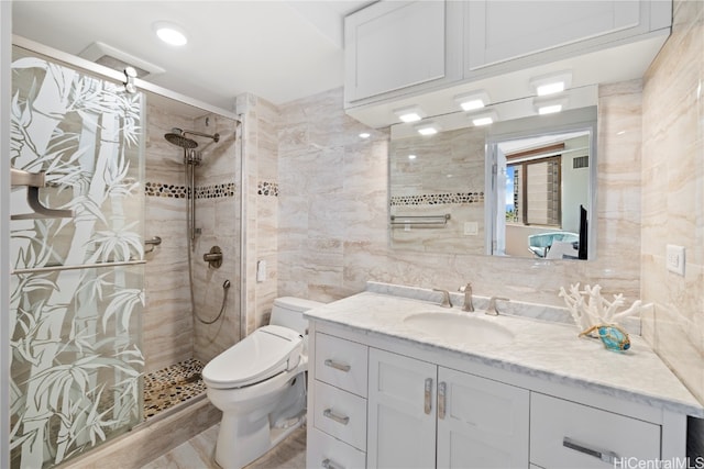 bathroom with tasteful backsplash, tile walls, toilet, a shower with shower door, and vanity