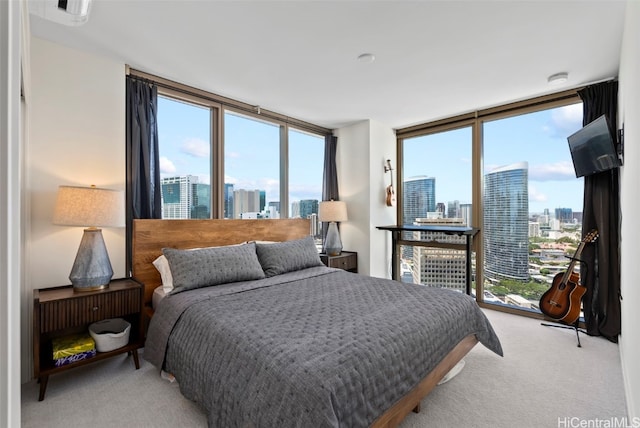 carpeted bedroom featuring a wall of windows