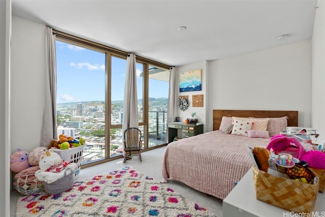 bedroom with access to outside, multiple windows, and floor to ceiling windows