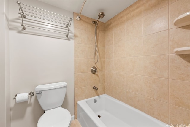 bathroom with toilet and tiled shower / bath combo