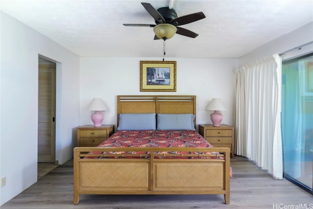 bedroom featuring ceiling fan, hardwood / wood-style flooring, and access to outside