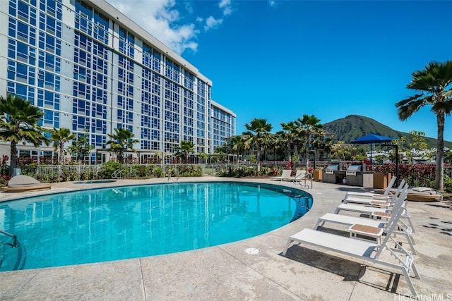 view of pool featuring a mountain view and a patio