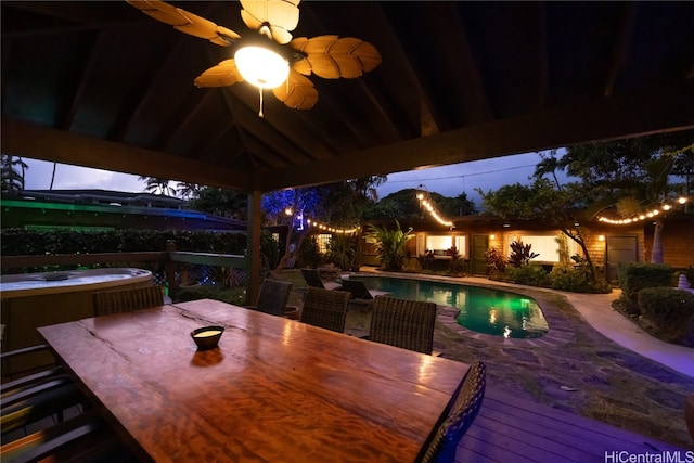 view of patio / terrace featuring a gazebo, a deck, and an in ground hot tub