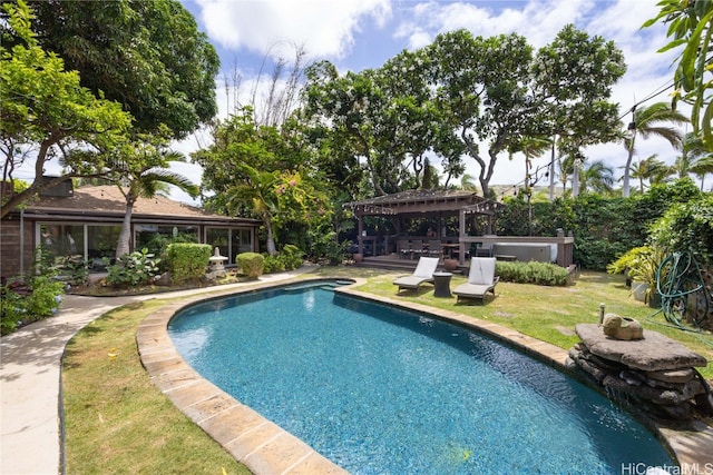 view of pool with a yard and a hot tub