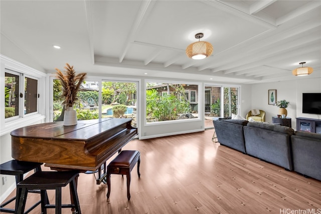 interior space with beam ceiling and hardwood / wood-style floors