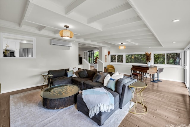 living room featuring beamed ceiling, light hardwood / wood-style flooring, and a wall mounted AC