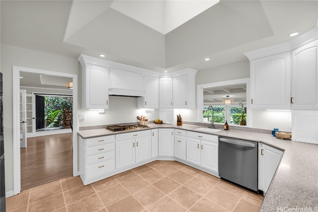 kitchen with a healthy amount of sunlight, white cabinetry, sink, and appliances with stainless steel finishes