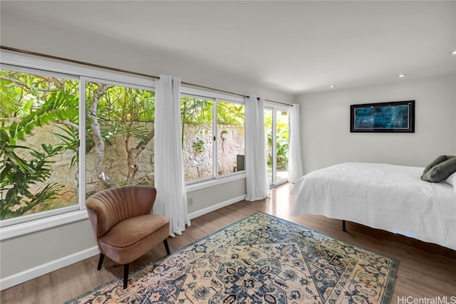 bedroom featuring hardwood / wood-style flooring and access to exterior