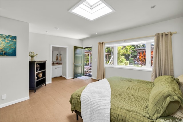 bedroom with a skylight and ensuite bath