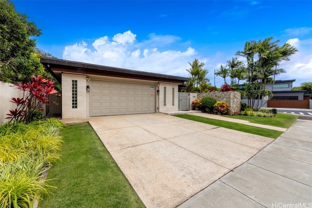 ranch-style home with a garage and a front lawn