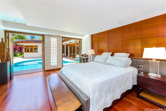 bedroom featuring hardwood / wood-style floors and access to outside