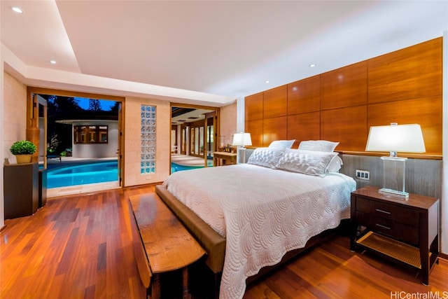 bedroom with access to exterior and hardwood / wood-style floors