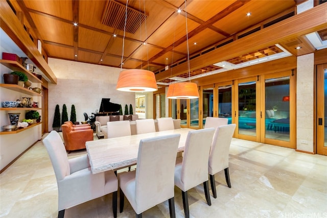 dining room featuring wood ceiling, a towering ceiling, and coffered ceiling