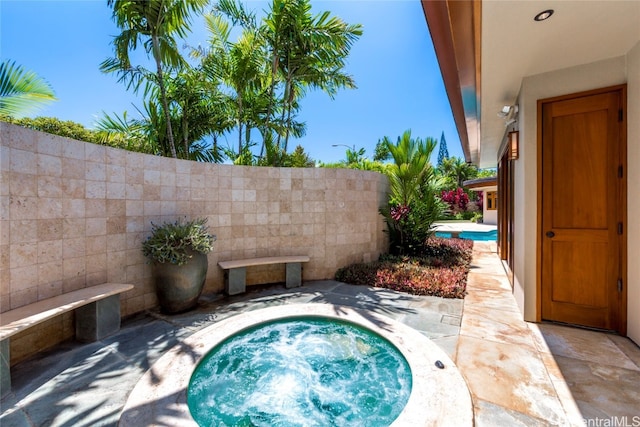 view of pool with an in ground hot tub and a patio area