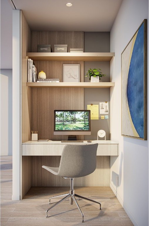 home office featuring built in desk and light hardwood / wood-style flooring