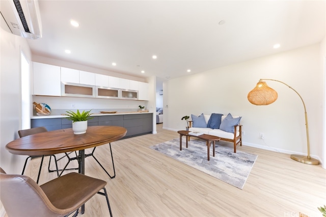 interior space featuring light hardwood / wood-style flooring and an AC wall unit