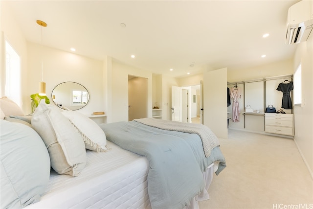 carpeted bedroom featuring an AC wall unit