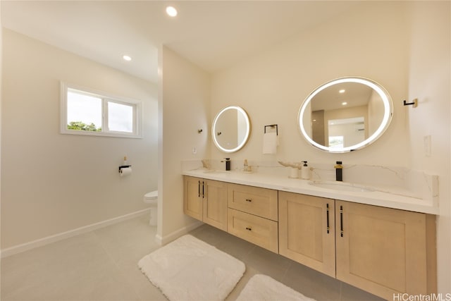 bathroom featuring toilet, tile patterned floors, and vanity