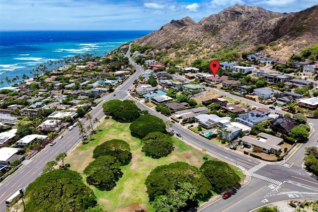 birds eye view of property with a water and mountain view