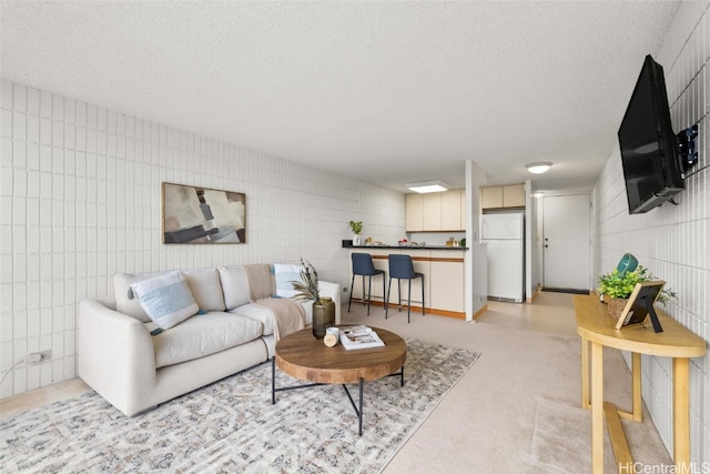 living room with a textured ceiling and light colored carpet